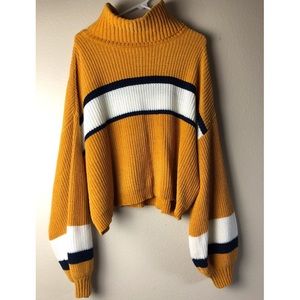 Knit sweater w/ bell shaped sleeves & turtle neck